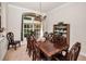 Bright dining room featuring a dark wood dining table set and large window offering exterior views at 1802 Oak Ridge Rd, Safety Harbor, FL 34695