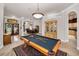 Open floor plan with a pool table as a focal point to living, dining, and kitchen area at 1802 Oak Ridge Rd, Safety Harbor, FL 34695