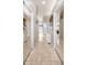 Well-lit hallway with tiled floors, mirrored closet doors, and neutral color palette at 1802 Oak Ridge Rd, Safety Harbor, FL 34695