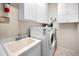 Laundry room featuring white cabinets, sink and a washing machine and dryer at 1802 Oak Ridge Rd, Safety Harbor, FL 34695