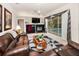 Spacious living room featuring an entertainment center, fireplace, and sliding glass doors leading to the pool area at 1802 Oak Ridge Rd, Safety Harbor, FL 34695