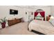 Bright main bedroom featuring a tray ceiling, en-suite access, and a serene atmosphere at 1802 Oak Ridge Rd, Safety Harbor, FL 34695