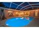 Night view of the backyard with a pool illuminated by underwater lights, complemented by patio at 1802 Oak Ridge Rd, Safety Harbor, FL 34695