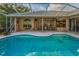 Screened-in pool area with outdoor seating on the patio at 1802 Oak Ridge Rd, Safety Harbor, FL 34695
