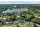 Beautiful aerial view of home surrounded by lush trees with water access to Lake Okahumpka at 18816 Tracer Dr, Lutz, FL 33549