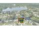 Aerial view of home with waterfront access to lake, surrounded by lush trees, marked in red for location at 18816 Tracer Dr, Lutz, FL 33549