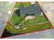 A bird's-eye view of a home on a waterway, outlined in red, features a dock and fenced yard at 18816 Tracer Dr, Lutz, FL 33549