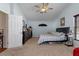 A serene bedroom is displayed with calming colors, vaulted ceilings, and a ceiling fan for added comfort at 18816 Tracer Dr, Lutz, FL 33549