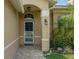 Inviting front entry with stone-paved porch and well-kept landscaping with 'Private Property' sign at 18816 Tracer Dr, Lutz, FL 33549