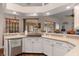A well-lit kitchen with white cabinets, stainless steel appliances and wood-look flooring at 18816 Tracer Dr, Lutz, FL 33549
