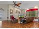 Bright living room with a fireplace, wood floors, neutral colors, and a large window with seating at 18816 Tracer Dr, Lutz, FL 33549