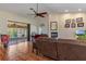 Spacious living room featuring a vaulted ceiling, wood floors, fireplace, and sliding glass doors to lanai at 18816 Tracer Dr, Lutz, FL 33549
