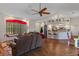 Expansive open-concept living room with a fireplace, window seat, wood floors, and views into the kitchen at 18816 Tracer Dr, Lutz, FL 33549