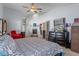 Inviting bedroom featuring a ceiling fan, and fireplace, creating a comfortable retreat at 18816 Tracer Dr, Lutz, FL 33549