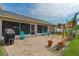 Outdoor patio features brick pavers, swing set, four chairs, and access to screened in porch at 18816 Tracer Dr, Lutz, FL 33549