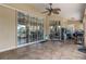 The outdoor patio features tile flooring, a ceiling fan, and sliding glass doors that lead to the interior at 18816 Tracer Dr, Lutz, FL 33549