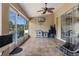 The airy enclosed patio overlooks the fenced backyard, perfect for relaxing or entertaining in a serene environment at 18816 Tracer Dr, Lutz, FL 33549