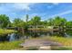 Scenic view of a waterfront with a dock surrounded by lush greenery and a calm waterway at 18816 Tracer Dr, Lutz, FL 33549
