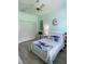 Bright bedroom features a ceiling fan, a plush bed, and ample closet space at 19709 Wyndham Lakes Dr, Odessa, FL 33556