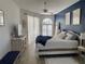 Serene bedroom with blue accent wall, plush bedding, and abundant natural light at 19709 Wyndham Lakes Dr, Odessa, FL 33556