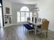 Bright dining area features a large window, a modern light fixture, and wood-look tile flooring at 19709 Wyndham Lakes Dr, Odessa, FL 33556