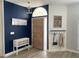 Inviting entryway with a wood door, stylish decor, and a blue accent wall at 19709 Wyndham Lakes Dr, Odessa, FL 33556