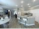 Bright kitchen with granite countertops, a breakfast bar, and stainless steel appliances open to living spaces at 19709 Wyndham Lakes Dr, Odessa, FL 33556