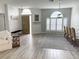 Open-concept living area showcasing wood-look tile floors and plantation shutters at 19709 Wyndham Lakes Dr, Odessa, FL 33556
