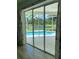 The screened-in patio overlooks a private pool with tropical landscaping and scenic views at 19709 Wyndham Lakes Dr, Odessa, FL 33556