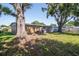 The backyard features mature trees offering plenty of shade and a grassy area at 2004 Windsor Way, Tampa, FL 33619