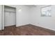 A bright bedroom offers a closet, hardwood floors, and a window at 2004 Windsor Way, Tampa, FL 33619