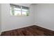 Bedroom with wood-look flooring and a large window with natural light at 2004 Windsor Way, Tampa, FL 33619