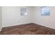 This bedroom features hardwood floors and two windows for ample natural light at 2004 Windsor Way, Tampa, FL 33619