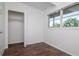 Bedroom with wood-look floors, a window view, and closet space at 2004 Windsor Way, Tampa, FL 33619