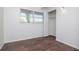 Bedroom with wood-look flooring, closet, and window overlooking outside at 2004 Windsor Way, Tampa, FL 33619