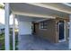 View of covered carport next to house with front door at 2004 Windsor Way, Tampa, FL 33619