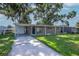 Charming single-story home with a covered driveway and spacious front yard at 2004 Windsor Way, Tampa, FL 33619