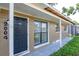 Close-up of the home's entrance with covered porch and traditional front door at 2004 Windsor Way, Tampa, FL 33619