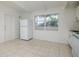 Kitchen featuring white appliances and cabinets, bright light, and tile floor at 2004 Windsor Way, Tampa, FL 33619