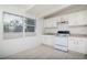 Bright kitchen with white cabinets, tile floor, and natural light from large windows at 2004 Windsor Way, Tampa, FL 33619