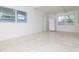 Spacious living room with tile floors, natural light, and view of the entry door at 2004 Windsor Way, Tampa, FL 33619