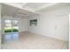 Living room with bright light from the large windows and two entry doors at 2004 Windsor Way, Tampa, FL 33619