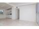 Open-concept living space with tiled floors leading to a kitchen and hallway at 2004 Windsor Way, Tampa, FL 33619