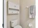 Bathroom with a toilet, wall cabinet, and towel rack with neutral walls at 2347 Willimette Dr, Wesley Chapel, FL 33543