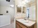 Bathroom features a large mirror and vanity, with coordinated lighting at 2347 Willimette Dr, Wesley Chapel, FL 33543