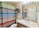Bathroom with a vanity, sink, and a striped shower curtain at 2347 Willimette Dr, Wesley Chapel, FL 33543