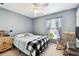 A quaint bedroom with grey walls and a window with natural light at 2347 Willimette Dr, Wesley Chapel, FL 33543