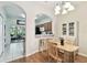 Dining area with hardwood floors next to the kitchen and featuring access to the patio at 2347 Willimette Dr, Wesley Chapel, FL 33543