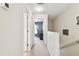 A hallway reveals a view of a bedroom, with a neutral-colored carpeted floor at 2347 Willimette Dr, Wesley Chapel, FL 33543