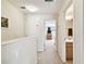 Hallway view showcasing bedroom and bathroom entrances with neutral carpet at 2347 Willimette Dr, Wesley Chapel, FL 33543